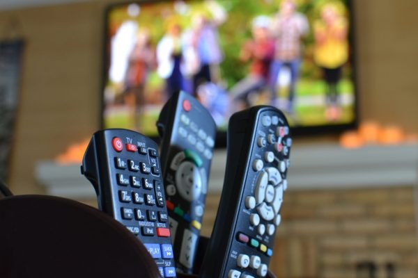 tv-remotes-with-a-television-with-people-playing-f-2023-11-27-05-23-25-utc tv-remotes-with-a-television-with-people-playing-f-2023-11-27-05-23-25-utc